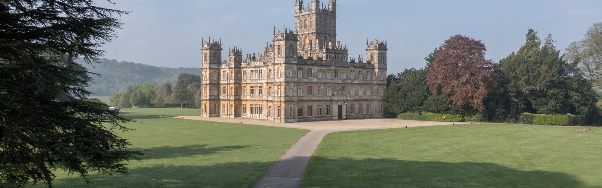 Drone shot of Highclere Castle showing castl front elevation and lawns